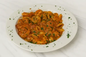 Greek food - Prawn pasta with tomato sauce and feta cheese